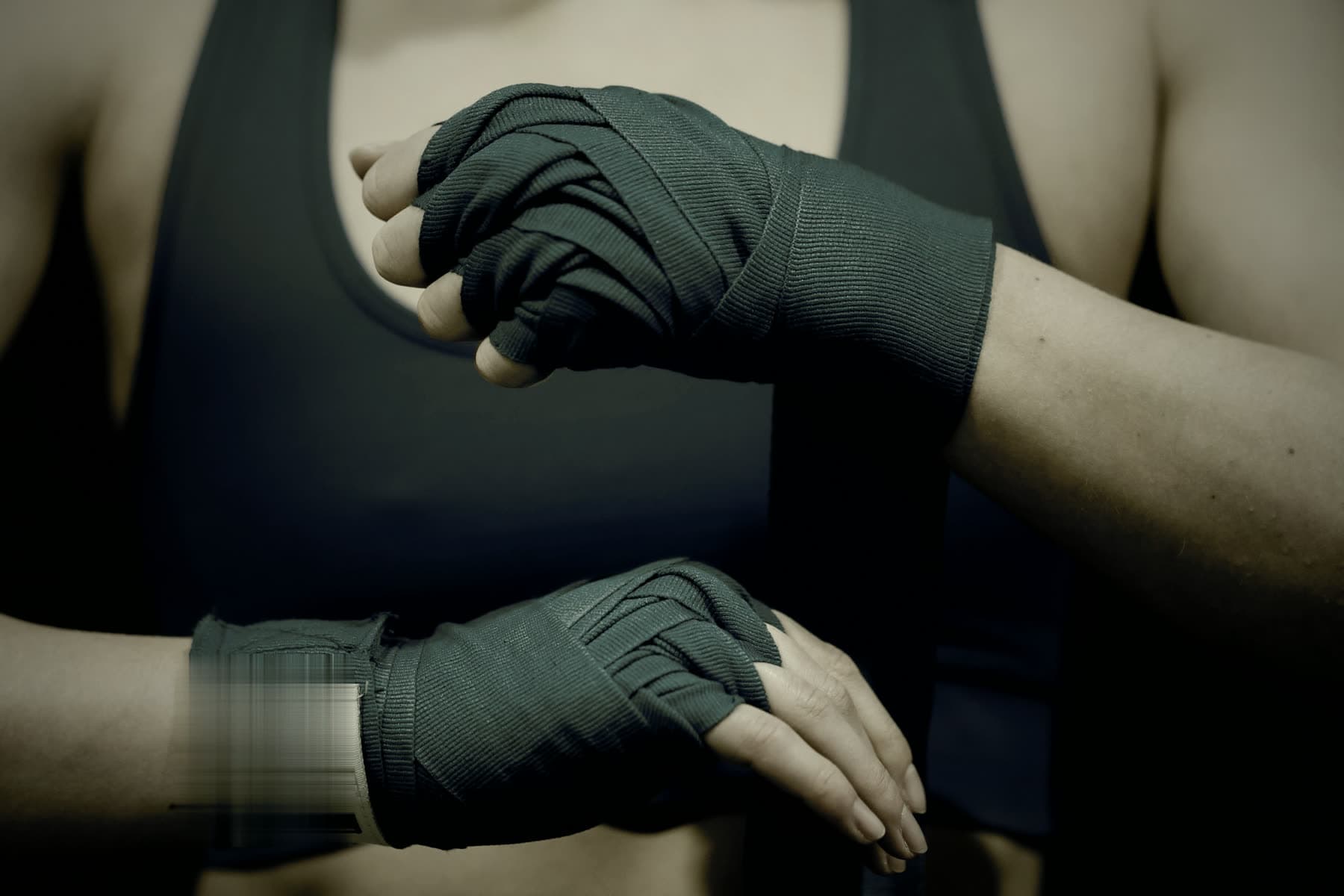 Close view of hands being wrapped before training, head out of frame